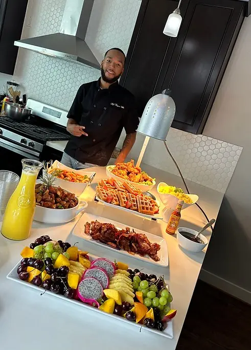 Chef T. White with a catering spread