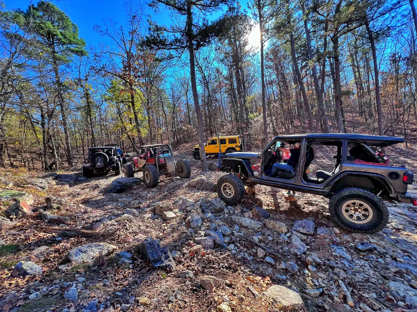 Lifted Jeep on a wooded trail