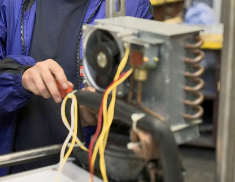 Technician replacing a washing machine part