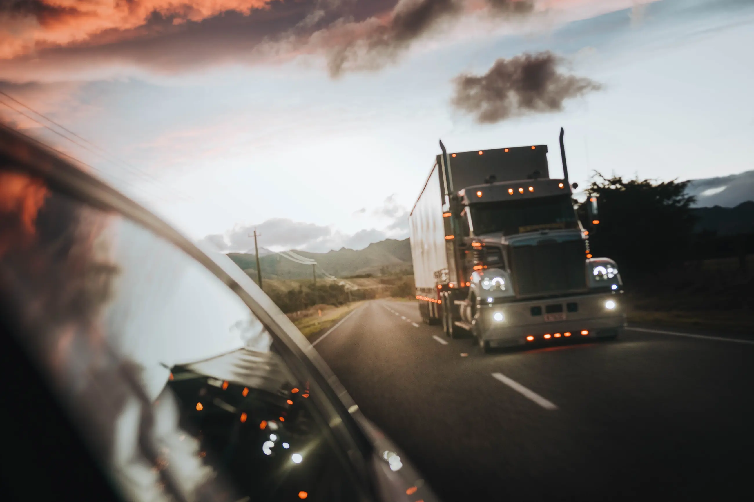 Semi truck on the highway at sunset