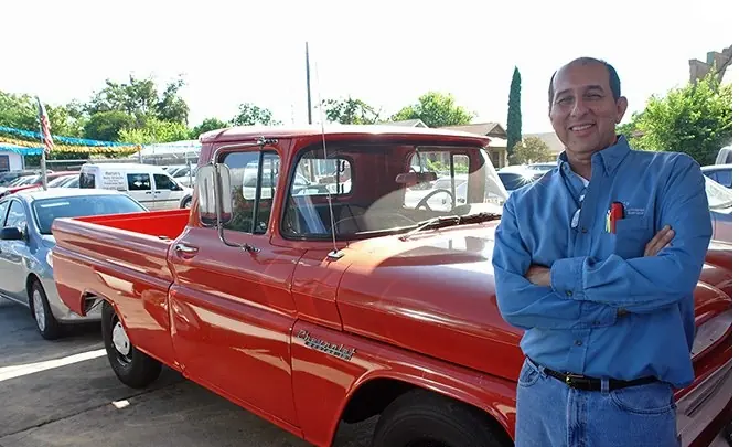 Owner Bill Montemayor with a classic red Chevrolet pickup