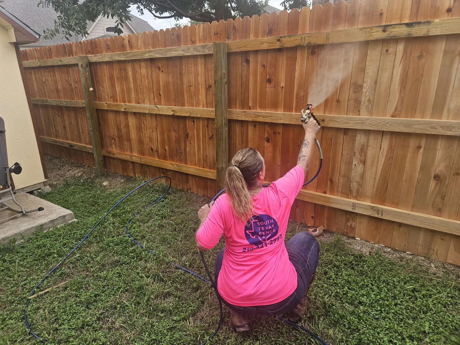 South Texas Fence crew staining a new wood fence